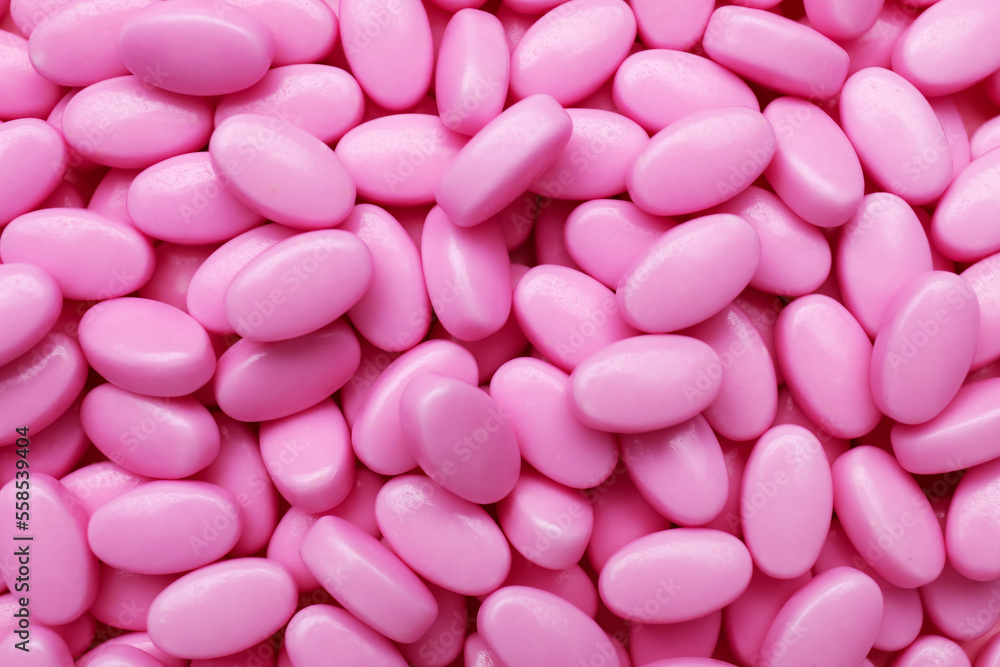 Many pink dragee candies as background, closeup