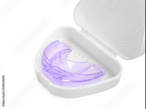Container with transparent dental mouth guard isolated on white. Bite correction