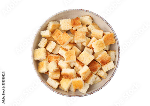 Delicious crispy croutons in bowl on white background, top view