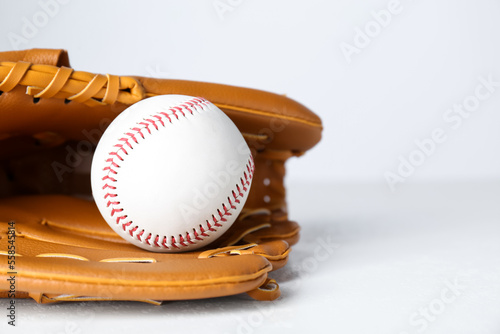 Catcher's mitt and baseball ball on white background, closeup with space for text. Sports game