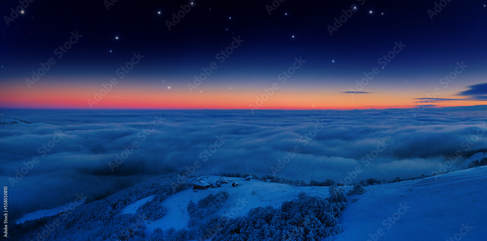 Snow-covered mountain peaks at dawn. View from a drone. Ukrainian Carpathian Mountains.