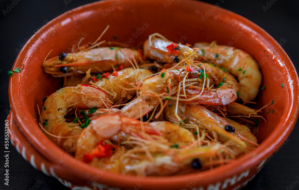 Grilled shrimp, Portuguese style with crushed chili peppers, garlic and parsley at an al fresco restaurant in Porto Grilled shrimp, Portuguese style with crushed chili peppers, garlic and parsley at an al fresco restaurant in Porto