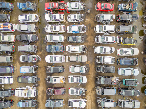 Aerial overhea shot of wrecked damaged cars at a automotive junk yard photo