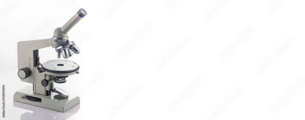 A microscope with three lenses on a white background. A microscope with three lenses on a white background.