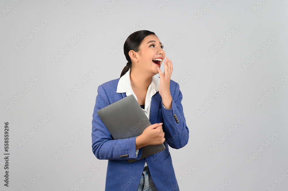 Young beautiful woman in formal clothing for officer holding laptop computer Young beautiful woman in formal clothing for officer holding laptop computer