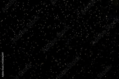 Raindrops on a black background. Abstract natural background. selective focus.