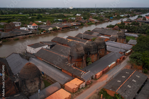Side on Aerial view of brick kilns and canal in Vinh Long in the Mekong Delta, Vietnam.