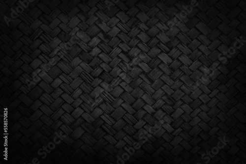 Old black bamboo weave texture background, pattern of woven rattan mat in vintage style.