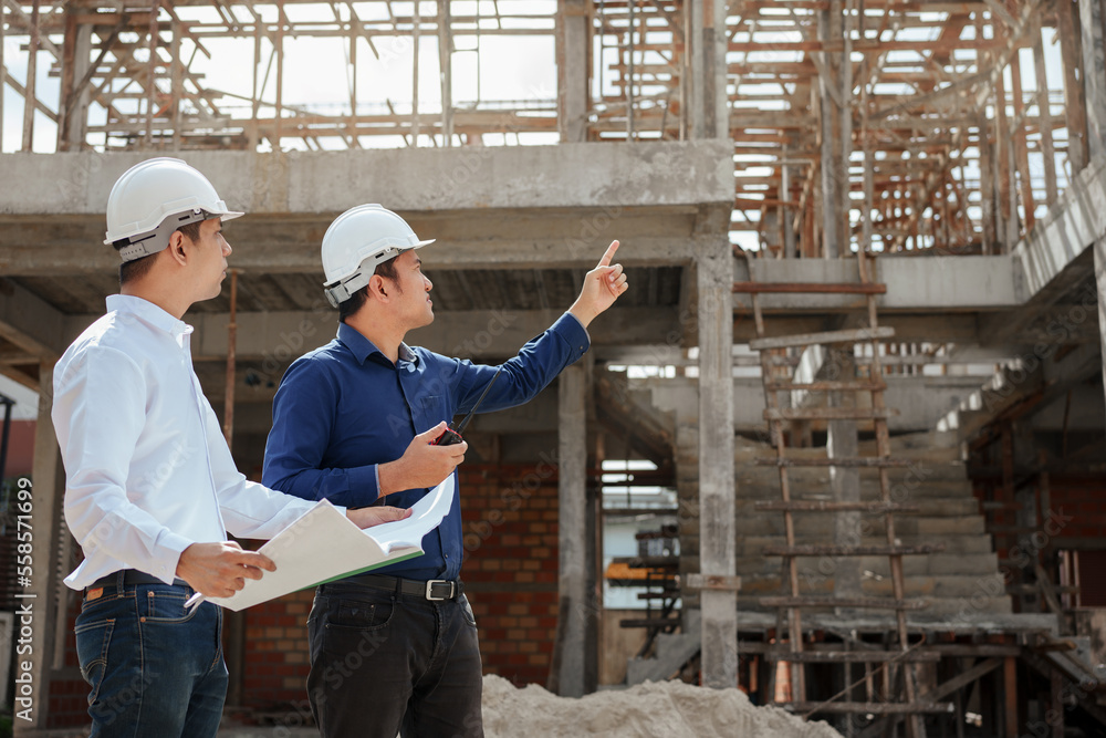 Construction engineer inspecting and working outdoors structure building site with blueprints. Construction engineer inspecting and working outdoors structure building site with blueprints.