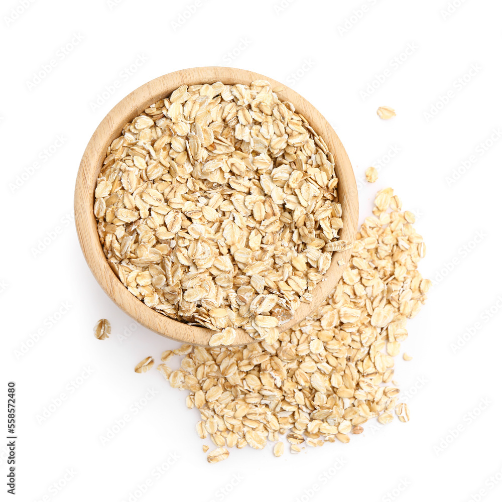 Bowl of raw oat flakes on white background