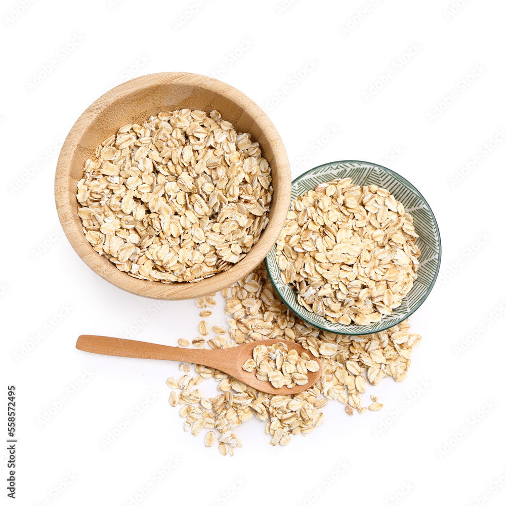 Bowls with raw oat flakes on white background Bowls with raw oat flakes on white background