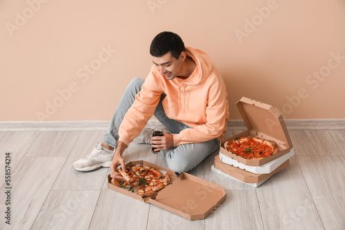Young man with boxes of tas...