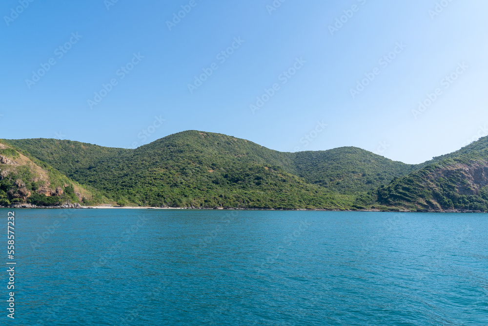 Natural landscape of green island and blue sea. Clear blue water, overlooking the wide sea, beautiful blue sea waves, Panoramic view of blue calm ocean. Natural landscape of green island and blue sea. Clear blue water, overlooking the wide sea, beautiful blue sea waves, Panoramic view of blue calm ocean.