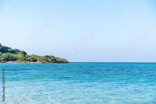 Natural landscape of green island and blue sea. Clear blue water  overlooking the wide sea  beautiful blue sea waves  Panoramic view of blue calm ocean.