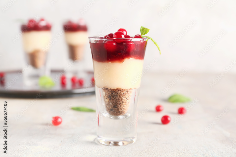 Shot of delicious pudding with cranberry, mint and jam on light table Shot of delicious pudding with cranberry, mint and jam on light table