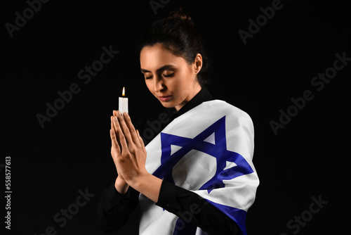 Young woman with candle and...
