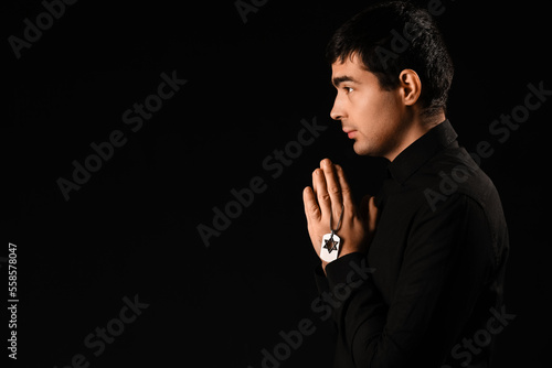 Praying Jewish man on dark ...