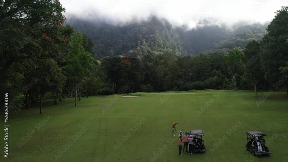 Aerial view of golf players at green field. High quality 4k footage Aerial view of golf players at green field. High quality 4k footage