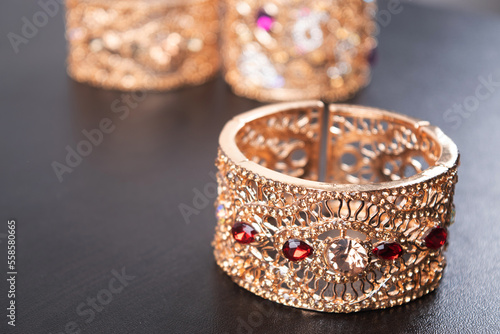 red stone gold bangle on table, semi precious jewelery