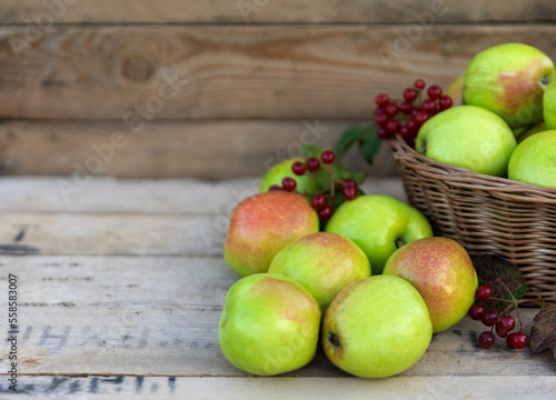 Healthy organic apples in a basket on a wooden background. The concept of a healthy diet.
