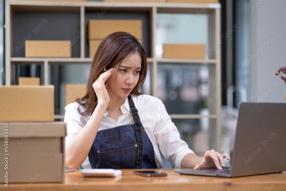 Young Asian business entrepreneur stress in online business, failure woman with working problem. SME entrepreneur and Online selling concept. Young Asian business entrepreneur stress in online business, failure woman with working problem. SME entrepreneur and Online selling concept.