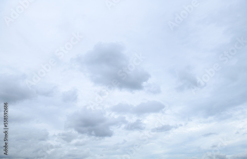 Storm clouds floating in a rainy day with natural light. Cloudscape scenery, overcast weather above blue sky. White and grey clouds scenic nature environment background
