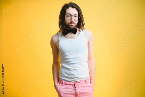Gay man on a colored background in the studio. The concept of the LGBTQ community. Equality.