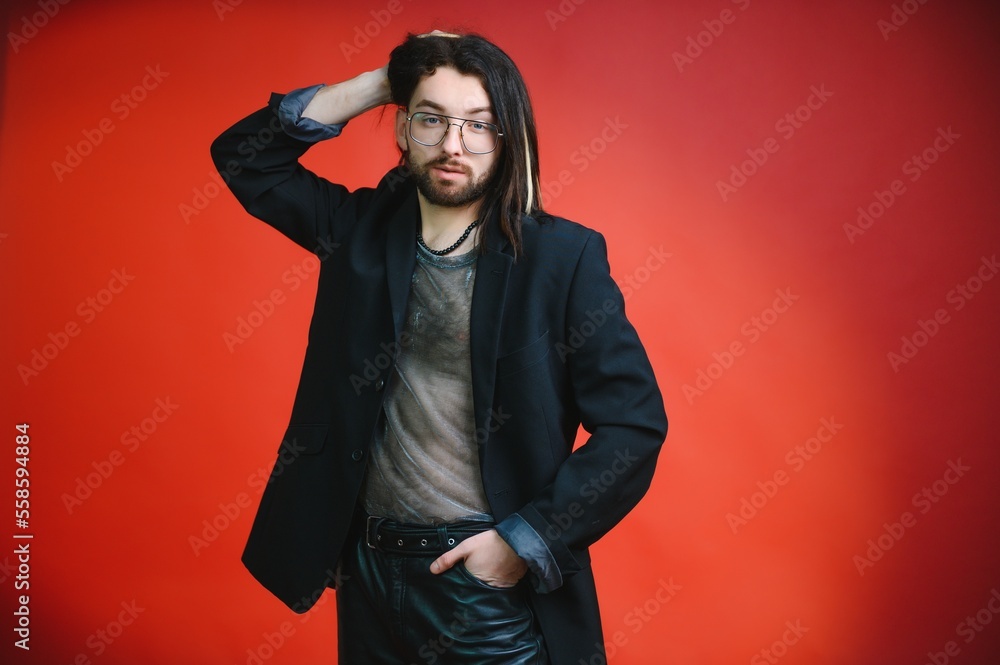 Gay man on a colored background in the studio. The concept of the LGBTQ community. Equality. Gay man on a colored background in the studio. The concept of the LGBTQ community. Equality.