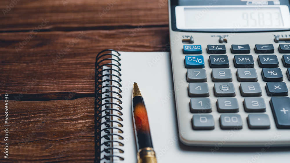 calculator, pen and notebook on a wooden background. Concept of business, finance, education calculator, pen and notebook on a wooden background. Concept of business, finance, education