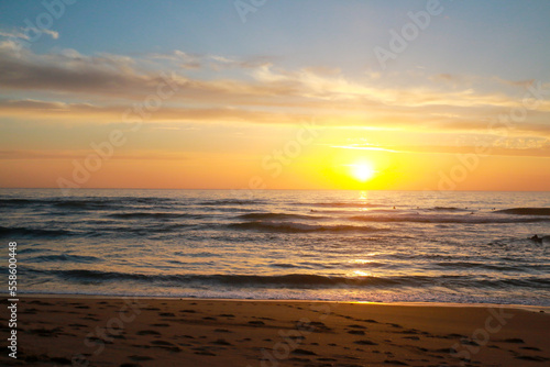 Beautiful sunset at the beach in portugal at the atlantic ocean close to lissabon. Wallpaper surf