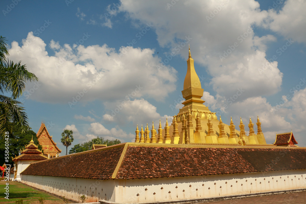 Naklejka premium Wallpaper of Vientiane the golden city with sleeping buddha statue and golden temple. Popular for the giant gate. Asia