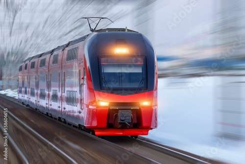 Railway track turn motion blur effect against winter snowy weather. Travel, railway tourism. Blurred railway.