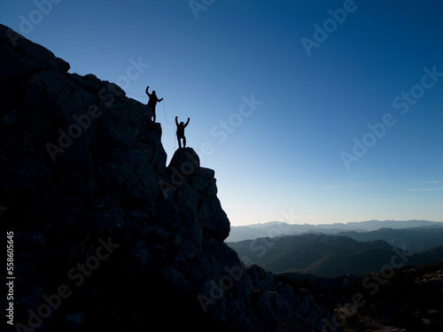 successful climbers in rock climbing with rope