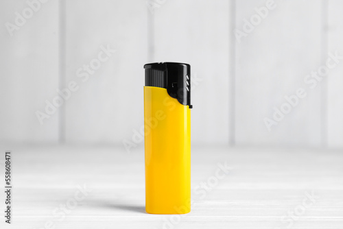 Stylish small pocket lighter on white wooden table