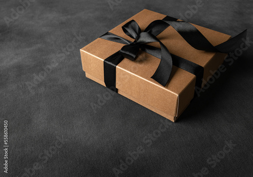 Gift box on a black background. Background with light haze.