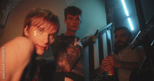 Three friends sit on staircase hanging out 