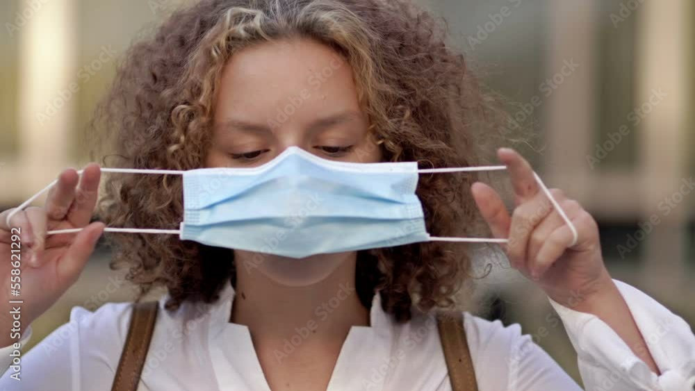 Portrait of a teenage girl putting on a protective mask. Close-up. Portrait of a teenage girl putting on a protective mask. Close-up.