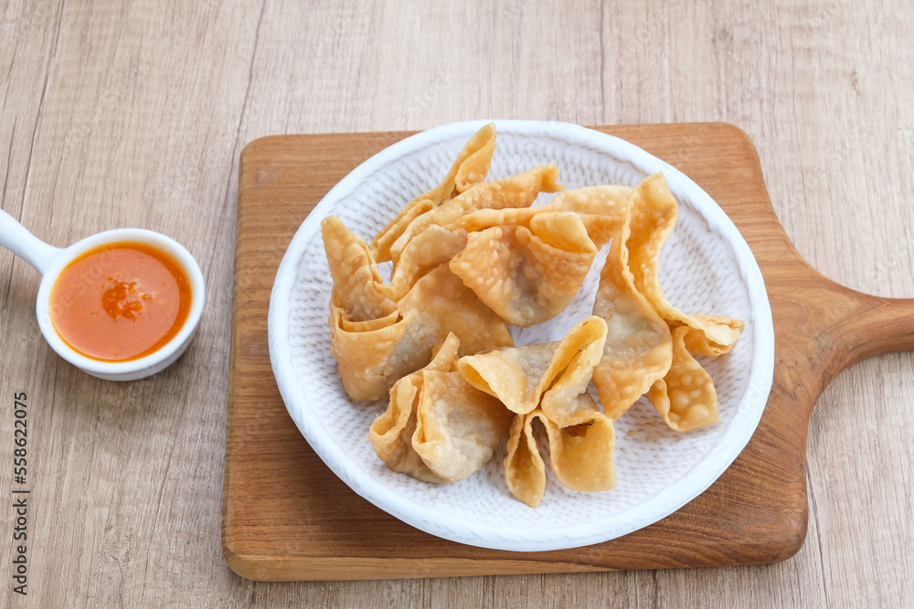 Pangsit Goreng (Chicken Fried Dumpling), Indonesian Traditional Food. Served with sauce
Pangsit Goreng (Chicken Fried Dumpling), Indonesian Traditional Food. Served with sauce
