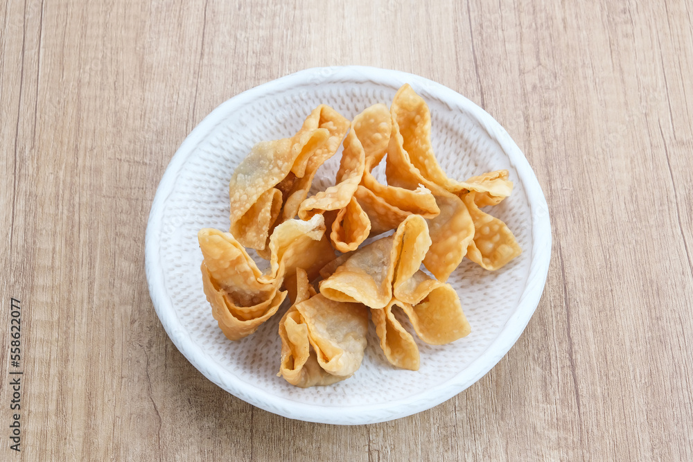 Pangsit Goreng (Chicken Fried Dumpling), Indonesian Traditional Food. Served with sauce
Pangsit Goreng (Chicken Fried Dumpling), Indonesian Traditional Food. Served with sauce