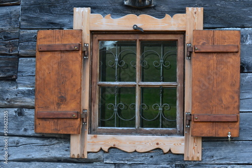 Carved window of an Alm wooden hut in Bavaria