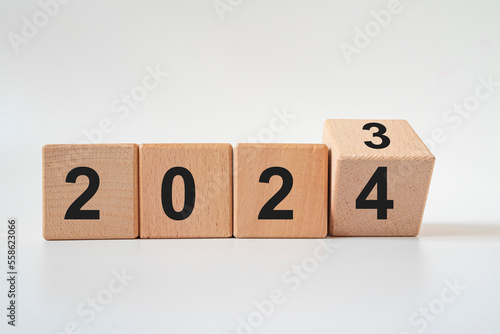 Hand translated wooden cube from 2023 to 2024.new business goal strategy concept.2024 goal planning business concept