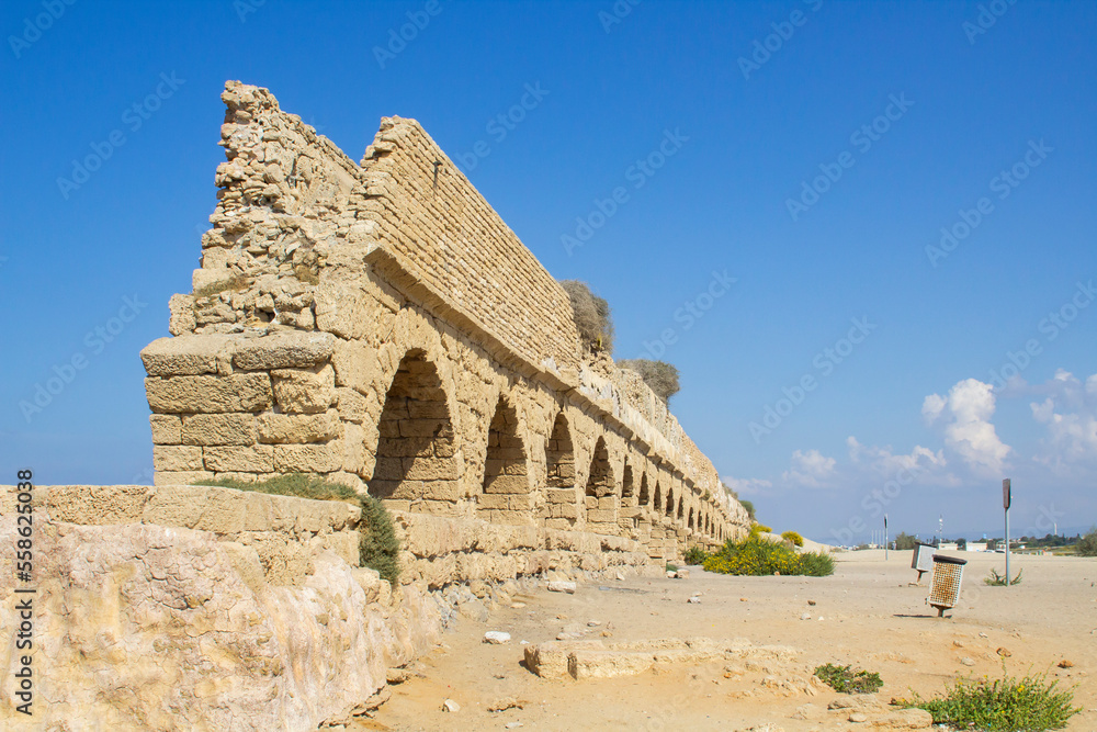 A section of the magnificent ancient Roman aquaduct, where it crosses the beach at Caeserea Maritima on the Mediterranean Coast Israel