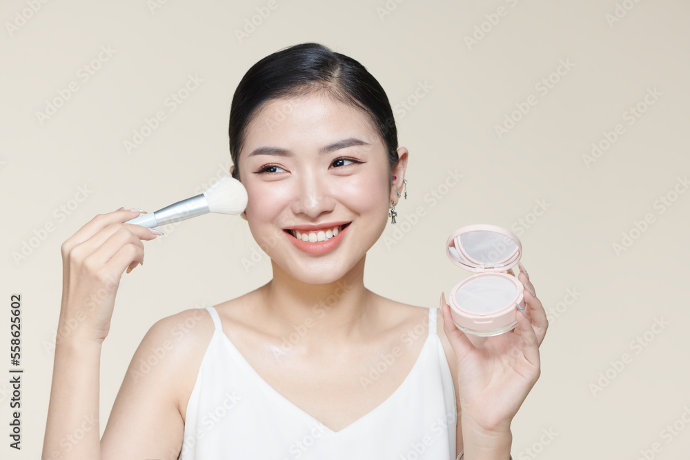 Powder blush woman Asian appearance smile and makeup brush Powder blush woman Asian appearance smile and makeup brush