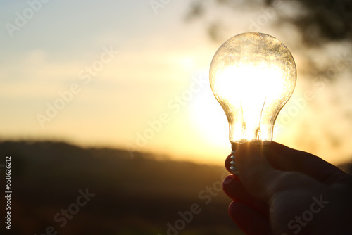 energy and business concept image. Creative idea and innovation. light bulb metaphor in front of the sun