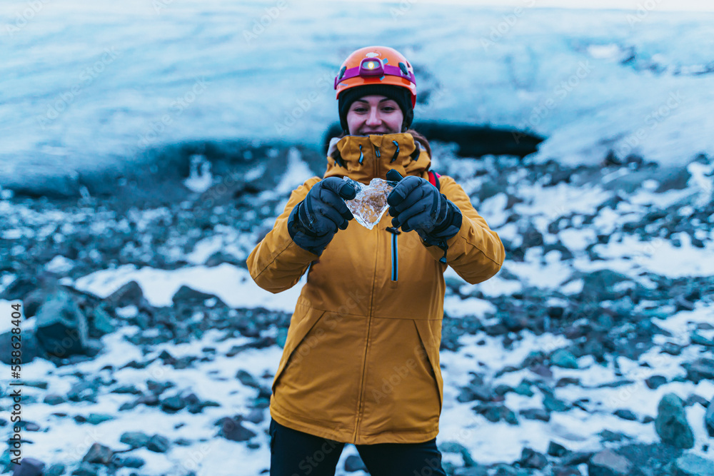 Woman with a piece of ice in the shape of a heart