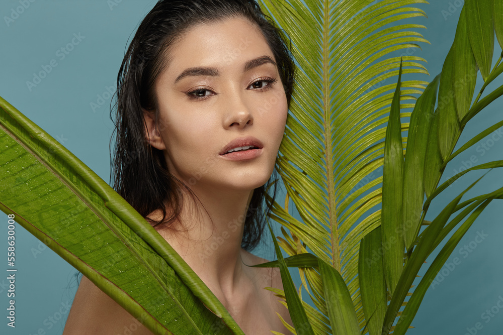 Girl peeking between tropical leaves. Natural beauty. Girl peeking between tropical leaves. Natural beauty.