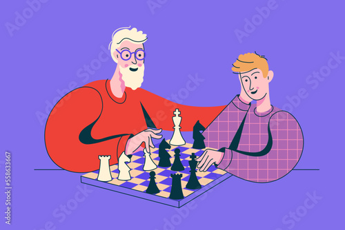 Grandfather playing chess with his grandson. Peope sitting at the table with chessboard. Chess tournament between old and young boy.