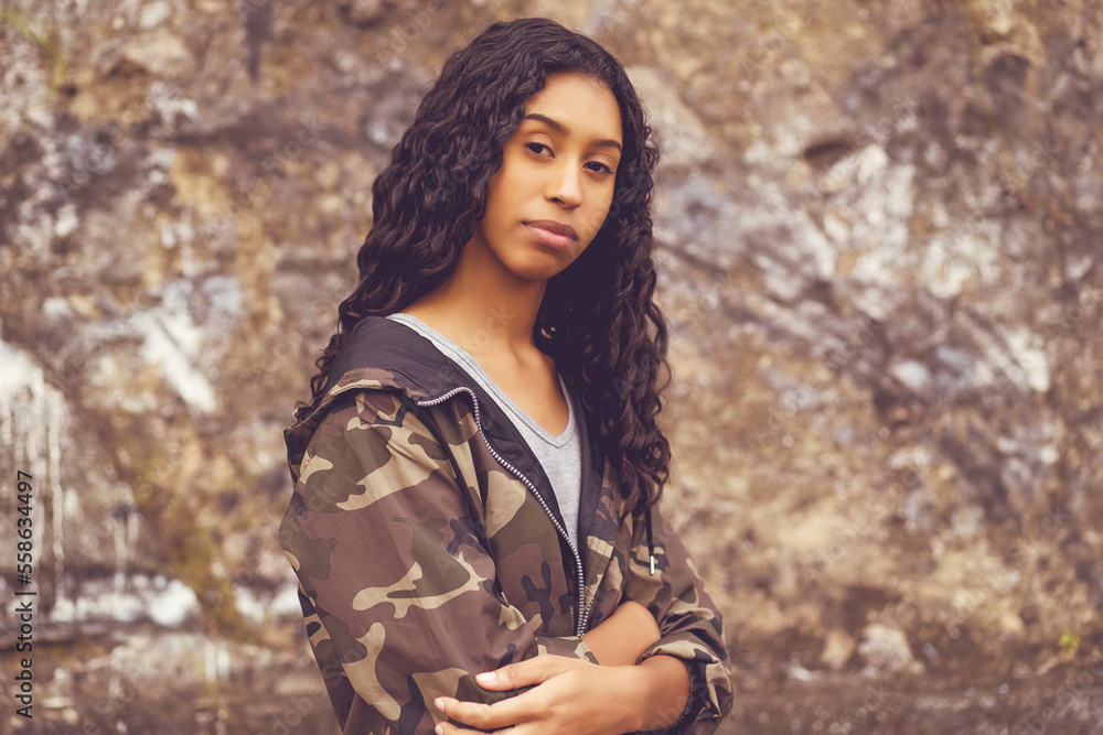 Shy mexican female young adult in camouflage clothing