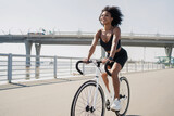 A happy woman rides a bicycle, leads a healthy lifestyle.