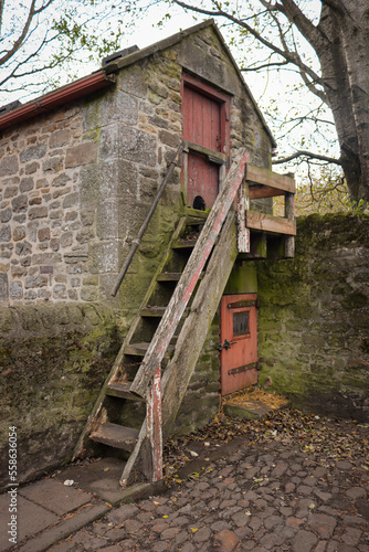 Wallpaper Mural Mossy wooden steps leading up to an old stone farm building in rural England. Torontodigital.ca